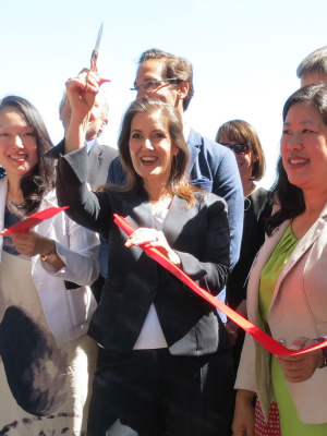 A group of people at a ribbon cutting